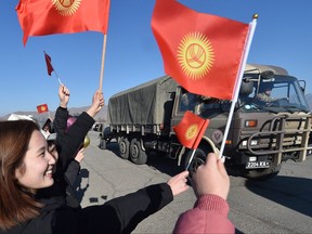 Relatives and people meet Kyrgyz troops, as they return from Kazakhstan, near the military unit in Tokmak some 60 kms from Bishkek, on Jan. 14, 2022.