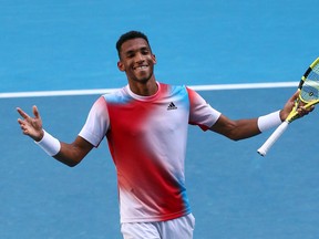 Canada's Felix Auger-Aliassime celebrates after winning the match against Croatia's Marin Cilic during their men's singles match on day eight of the Australian Open tennis tournament in Melbourne on January 24, 2022.