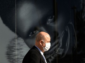 A man wearing a face mask walks in a street in Madrid on Jan. 27, 2022.