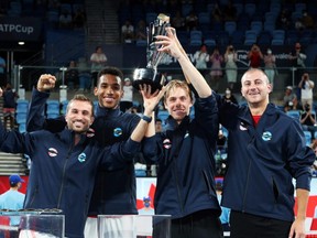 Canada's Steven Diez, Felix Auger-Aliassime, Denis Shapovalov and Brayden Schnur pose with the trophy as they celebrate after winning the ATP Cup at Sydney Olympic Park in Sydney, Australia, Sunday, Jan. 9, 2022.