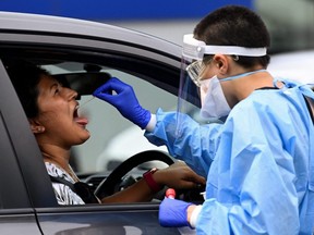 A woman takes a test for COVID-19 at a testing centre in Sydney, Australia, Jan. 5, 2021.