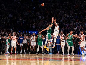 New York Knicks guard RJ Barrett (9) makes a game-winning three point basket during the fourth quarter as Boston Celtics forward Jayson Tatum (0) defends at Madison Square Garden Jan. 6, 2022.