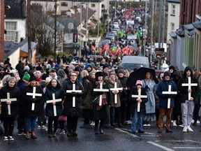 Families of the victims and supporters hold crosses as they take part in Bloody Sunday March to the Guildhall, as they mark the 50th Anniversary of Bloody Sunday, on Jan. 30, 2022 in Londonderry, also known as Derry, Northern Ireland.