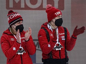 Canada's Christine de Bruin and Kristen Bujnowski celebrate on the podium after finishing third in the 2-woman bobsleigh in Sigulda, Latvia.