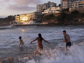 People enjoy warm weather at Bondi Beach at sunrise on Dec. 25, 2021 in Sydney, Australia.