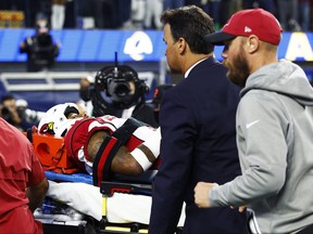 Budda Baker of the Arizona Cardinals is carted off the field after an injury during the third quarter against the Los Angeles Rams in the NFC Wild Card Playoff game at SoFi Stadium on Jan. 17, 2022 in Inglewood, Calif.