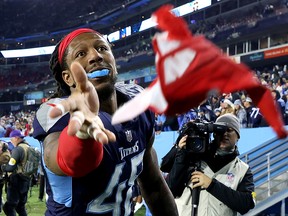 Bud Dupree of the Tennessee Titans tosses his gloves to fans after defeating the San Francisco 49ers at Nissan Stadium on December 23, 2021 in Nashville, Tennessee.
