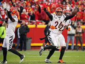 Bengals safety Vonn Bell (24) celeberates with cornerback Chidobe Awuzie (22) after an interception against the Chiefs in overtime during the AFC Championship Game at GEHA Field at Arrowhead Stadium in Kansas City, Mo., Sunday, Jan. 30, 2022.