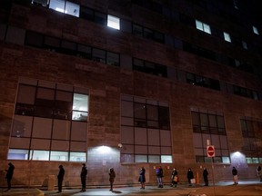 People queue up for their COVID-19 PCR test at Women's College Hospital, as the latest Omicron variant emerges as a threat, in Toronto, Dec. 22, 2021.