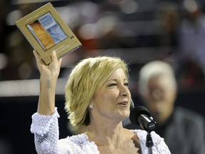 Chris Evert holds a DVD copy of The Barbarian Invasions at her induction to the Rogers Cup Hall of Fame during the Rogers Cup at Uniprix Stadium in Montreal, Aug. 16, 2010.
