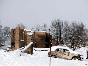 A snow covered car destroyed by the Marshall Fire is seen near destroyed homes in the Rock Creek neighbourhood of Superior in Boulder County, Col., on Jan. 1, 2022.