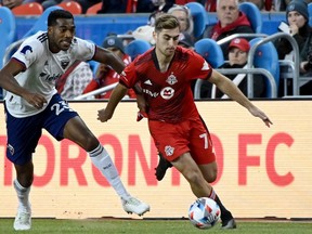 Toronto FC's Jordan Perruzza, right, is chased down by tackles D.C. United's Donovan Pines during second half MLS soccer action in Toronto on Sunday, Nov. 7, 2021.