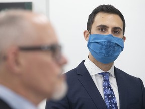 Ontario Education Minister Stephen Lecce looks over at Dr Kieran Moore, Ontario's Chief Medical Officer of Health at a news conference held in Toronto on Thursday, November 18, 2021.