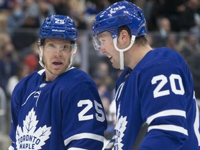 Toronto Maple Leafs' Ondrej Kase (left) talks with Nick Ritchie during action against the Tampa Bay Lightning in Toronto, on December 9, 2021.