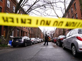 Philadelphia firefighters and police work at the scene of a deadly row house fire, Wednesday, Jan. 5, 2022, in the Fairmount neighbourhood of Philadelphia.