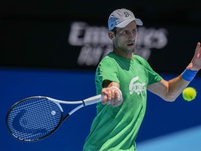 Defending men's champion Serbia's Novak Djokovic practices on Margaret Court Arena ahead of the Australian Open tennis championship in Melbourne, Australia, Thursday, Jan. 13, 2022.