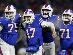 Buffalo Bills quarterback Josh Allen (17) celebrates after wide receiver Gabriel Davis (13) scores a touchdown during the second half of an NFL wild-card playoff football game against the New England Patriots, Saturday, Jan. 15, 2022, in Orchard Park, N.Y.