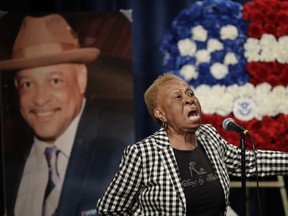 Janie Taylor sings beside a photo of Federal Protective Services Officer Dave Patrick Underwood on Friday, June 19, 2020, in Pinole, Calif.