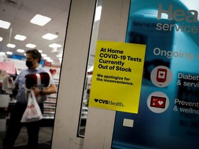 A sign informing customers that  COVID-19 tests are out of stock is seen at the entrance of a CVS pharmacy as the Omicron variant continues to spread through the country, in Miami, Wednesday, Jan. 5, 2022.