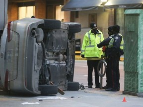 In this file photo, Toronto Police officers investigate a Boxing Day crash at  Yonge and Richmond Sts. which left an 18-year-old dead and seven others injured.