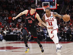Bulls' DeMar DeRozan drives to the basket against Raptors' fYuta Watanabe during the first half at United Center in Chicago on Wednesday, Jan. 26, 2022.