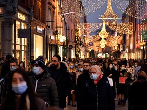 Christmas shoppers walk along Grafton Street in Dublin, Ireland, December 19, 2021.