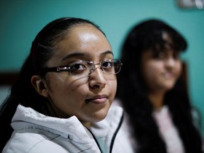 Guadalupe Estrella Salazar Calderon, 17, who is developing a sign-language translation app to connect Mexican Sign Language (MSL) speakers and interpreters with hearing users, poses for a photo with her sister Perla, at her house in the municipality of Nezahualcoyotl, Mexico December 30, 2021.