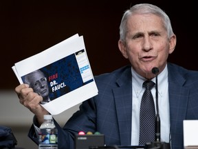 Dr. Anthony Fauci, White House Chief Medical Advisor and Director of the NIAID, shows a screen grab of a campaign website while answering questions from Sen. Rand Paul (R-KY) at a Senate Health, Education, Labor, and Pensions Committee hearing on Capitol Hill on Jan. 11, 2022 in Washington, D.C.