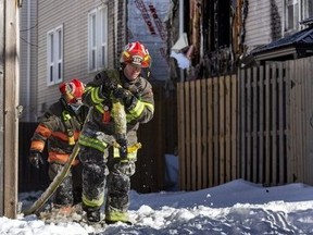 Firefighters at the scene of a triple fatal townhouse fire in Brampton, Ont., on Thursday, Jan. 20, 2022. PHOTO BY ERNEST DOROSZUK /Toronto Sun/Postmedia Network
