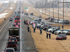Supporters of the "Freedom Convoy" of truckers gather on the edge of the Trans-Canada Highway east of Calgary, Monday. 



Gavin Young/Postmedia ORG XMIT: POS2201241210050849