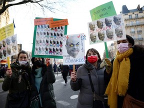 French teachers attend a demonstration as part of a nationwide day of strike and protests against health conditions in schools, in Paris amid the rise of COVID-19 cases due to the Omicron variant in France, Thursday, Jan. 13, 2022.