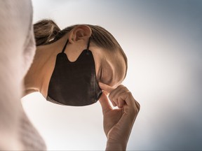 Closeup of tired stressed woman wearing face mask. Coronavirus concept.