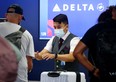 A Delta Air Lines employee works on the departures level at Los Angeles International Airport (LAX) on August 25, 2021 in Los Angeles, California. (Photo by Mario Tama/Getty Images)