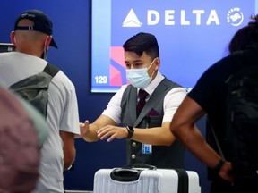 A Delta Air Lines employee works on the departures level at Los Angeles International Airport (LAX) on August 25, 2021 in Los Angeles, California. (Photo by Mario Tama/Getty Images)
