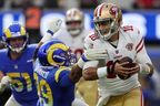 Aaron Donald  of the Los Angeles Rams attempts to sack Jimmy Garoppolo of the San Francisco 49ers in the second quarter of the game at SoFi Stadium on January 09, 2022 in Inglewood, California. 