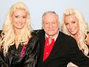 Holly Madison, left, Playboy founder Hugh Hefner, and Crystal Harris appear in Madison's dressing room after Hefner and his friends attended the adult production,