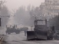 Servicemen and their military vehicles block a street in central Almaty, Kazakhstan, on Jan. 7, 2022, after violence that erupted following protests over hikes in fuel prices.