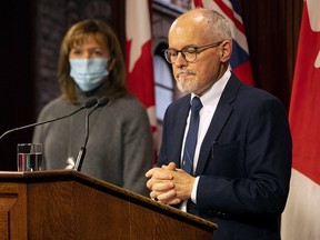 Ontario Chief Medical Officer Dr. Kieran Moore and Health Minister Christine Elliott attend a press briefing at the Ontario Legislature in Toronto, Friday, Dec. 10, 2021.