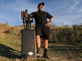 Los Angeles sculptor Dan Medina poses next to a temporary statue placed by him to honour the anniversary of the deaths of Kobe and Gigi Bryant along with seven other passengers where their helicopter crashed two years ago today in Calabasas, California January 26, 2022.