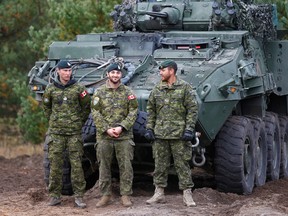 Canadian Army soldiers stand next to their LAV 6 armored personnel carrier during NATO enhanced Forward Presence battle group military exercise Silver Arrow in Adazi, Latvia October 5, 2019.