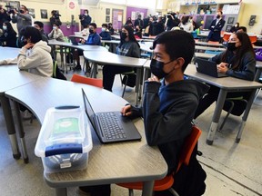 Seventh and eighth grades students attend a combined Advanced Engineering class at Olive Vista Middle School on the first day back following the winter break amid a dramatic surge in COVID-19 cases across Los Angeles County, in Sylmar, Calif., Tuesday, Jan. 11, 2022.