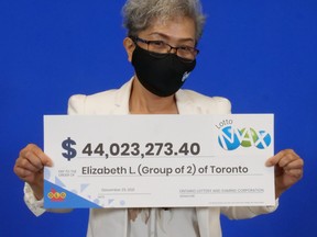 Elizabeth Lumbo holds her Lotto Max cheque.