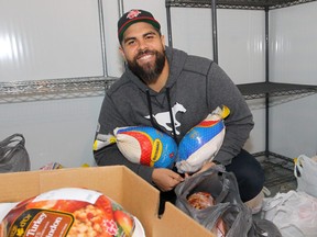 Corey Mace, then the defensive line coach of the Stampeders, poses with some frozen turkeys in the freezer at McMahon Stadium in Calgary two years ago. Mace, who was confirmed as the Argos’ new defensive co-ordinator on Thursday, along with his wife Petra, have run their annual Christmas turkey drive, generating more than a thousand meals for the less fortunate over the past nine years and endearing himself to the community.