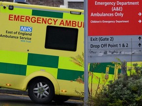 Ambulances are seen parked near the entrance of the Princess Alexandra Hospital Emergency Department, east of London, England, Saturday, Jan. 8, 2022.