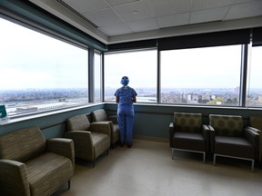 Registered nurse Stephanie Flores, who has been redeployed from the operating room to the intensive care unit, looks out the window in the ICU at the Humber River Hospital during the COVID-19 pandemic in Toronto on Tuesday, April 13, 2021.