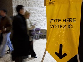 Citizens arrive and depart an Ontario provincial election polling station within Ottawa City Hall.