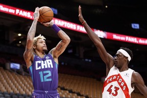 Kelly Oubre Jr. of the Charlotte Hornets puts up a shot over Pascal Siakam of the Raptors during the first half. COLE BURSTON/GETTY IMAGES