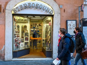 Pedestrians walk past the Stereosound record shop, located a few steps from the Pantheon in Rome, on January 12, 2022, a day after the Pope's visit.