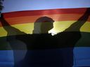 In this file photo taken on July 7, 2012, a participant holds a rainbow flag during a Pride parade in downtown Budapest.