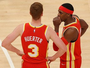 Rajon Rondo of the Atlanta Hawks communicates with Kevin Huerter against the Detroit Pistons at State Farm Arena on December 28, 2020 in Atlanta, Georgia.